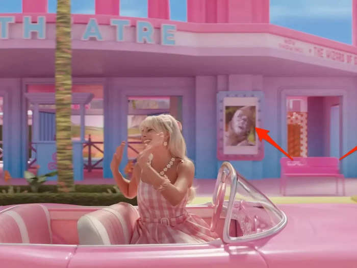 As Stereotypical Barbie drives through Barbie Land, she passes a movie theater marquee that