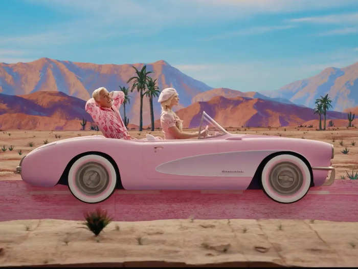 Barbie and Ken driving across the desert in a slightly undersized pink convertible is one of the film