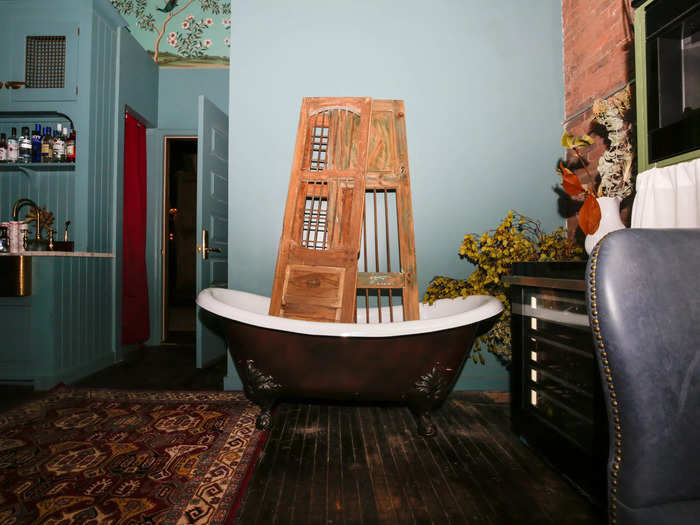 Downstairs, a large functioning bathtub grounds the dark bunker-like space as a photo opp and a place to keep buckets of ice and alcohol.