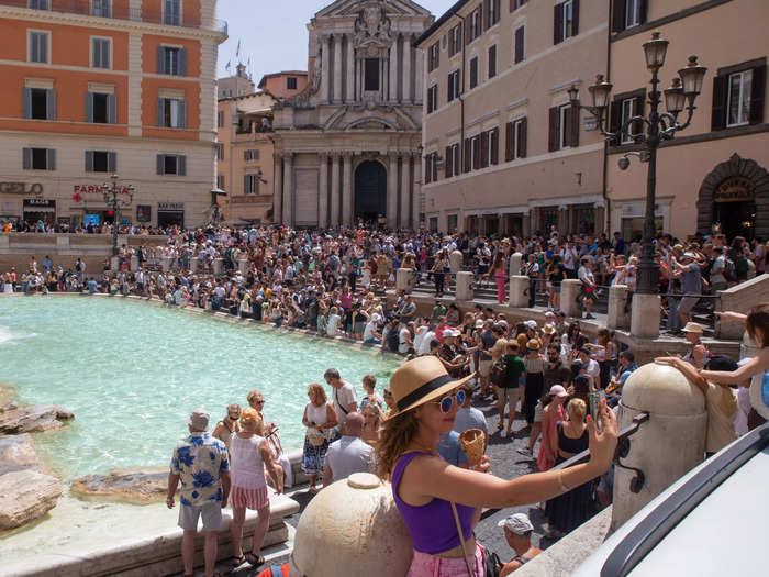 Amid the heatwave in Italy, tourists were photographed snapping selfies and crowding around the Trevi fountain.