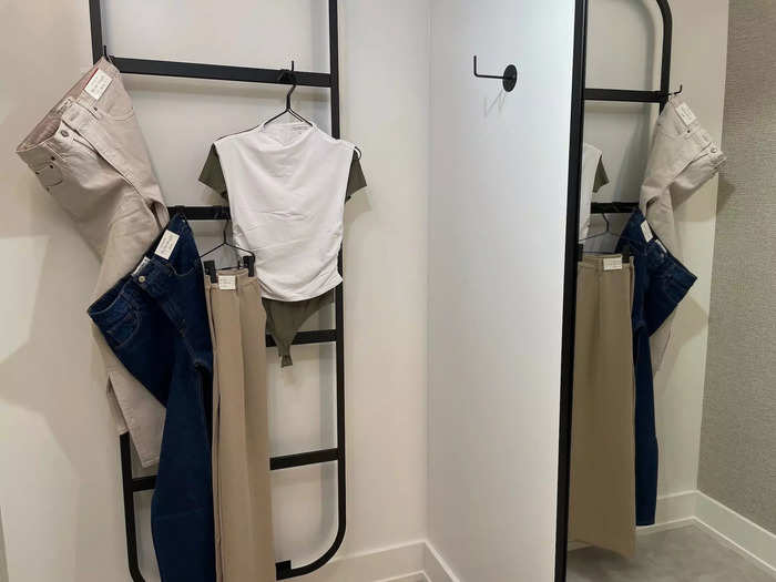 A store associate opened a room for me, and I was shocked by how beautiful it was. There was a minimalist ladder to hang my clothes on.