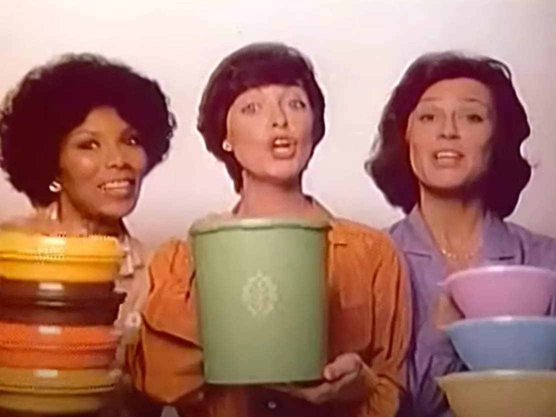 Three women holding Tupperware containers appear in a television ad for the brand in 1980.