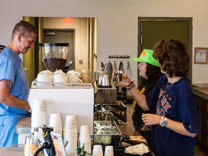 Baristas preparing coffee for a customer.