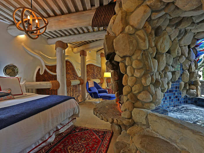 A private grotto, seen to the right, is located right off the primary suite bedroom, featuring a full spa.