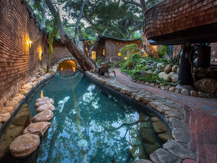 The lap pool is split, with 40 feet outside and 35 feet flowing inside the guest house.