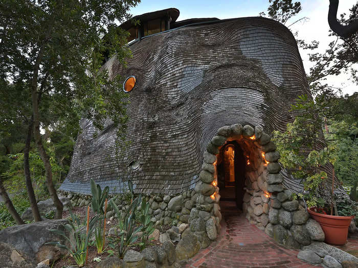 The structure is made of weathered grey shingles — similar to the color of a whale — that move in the breeze.