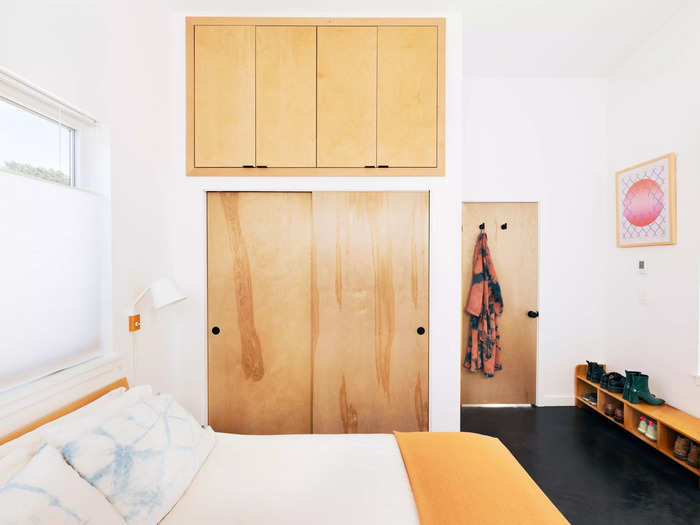 The bedrooms are designed to maximize storage space in the tiny home. Hutchins used the high ceilings to include a storage space on top of the closet.