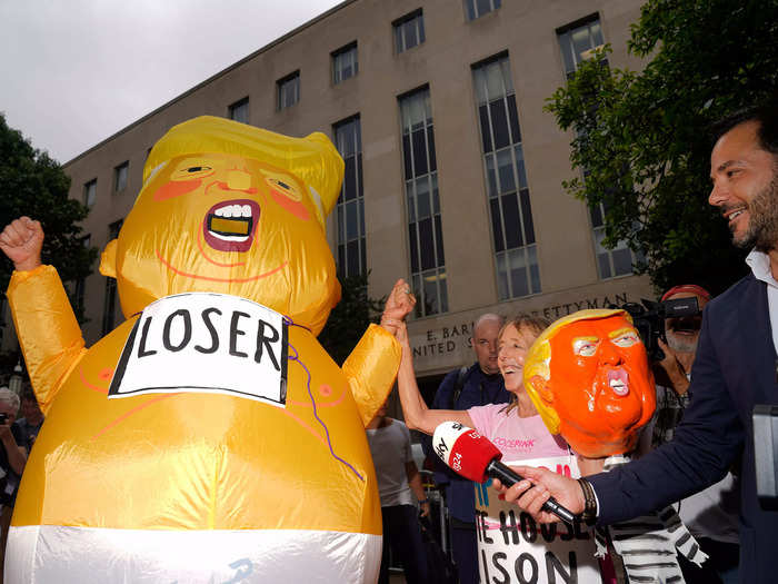 A protester dressed in a baby Trump costume, wearing a "Loser" sign. This was not the first time Trump was depicted as a baby by his detractors.