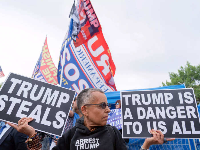 Some Trump supporters and anti-Trump protesters were grouped together. Below, Laurie Arbeiter held a sign that claimed, "Trump steals" and is a "danger to us all."