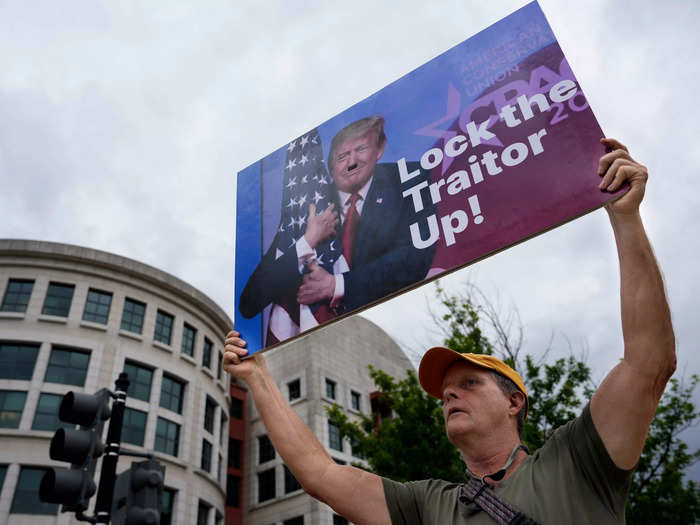 A protester held up a sign that riffed on a similar phrase Trump supporters chant against Hillary Clinton.