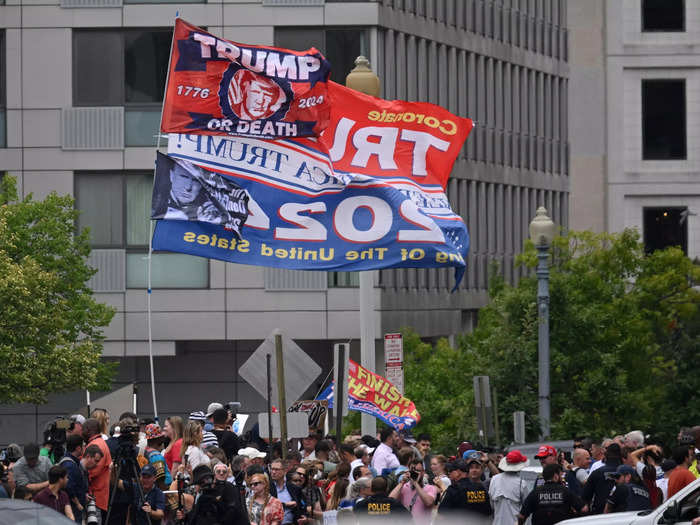 Trump supporters waved flags outside the federal courthouse. CNN earlier reported there was an underwhelming presence of Trump supporters outside of the courthouse.