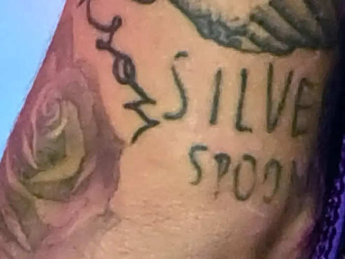 The name Arlo is tattooed below his "silver spoon" tattoo.