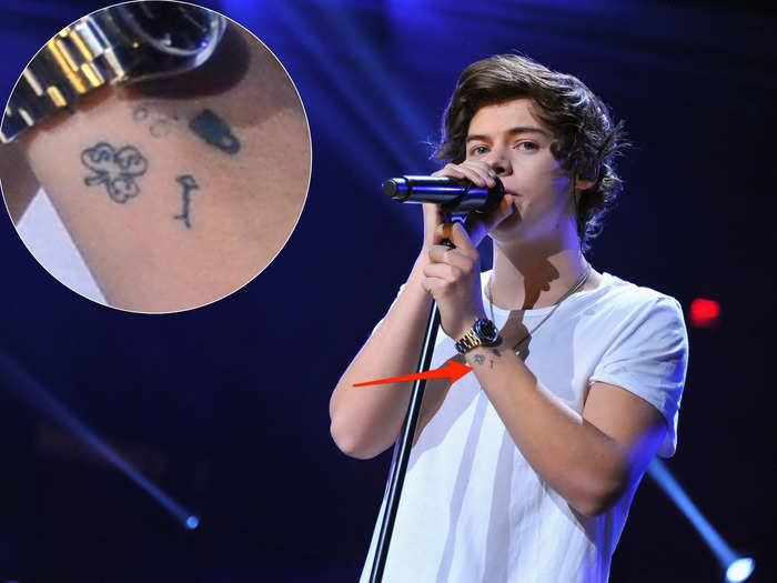 He has a cluster of small tattoos around his left wrist.