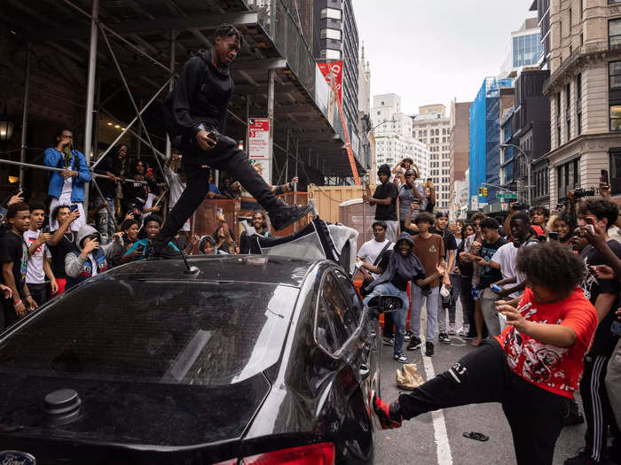 One fan danced on top of a parked car near Union Square Park while another appeared to kick a door.