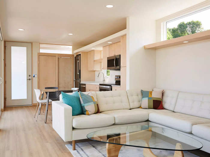 The entry door on the front porch opens into the joint kitchen and living room.