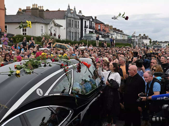 Some threw flowers at her cortege.