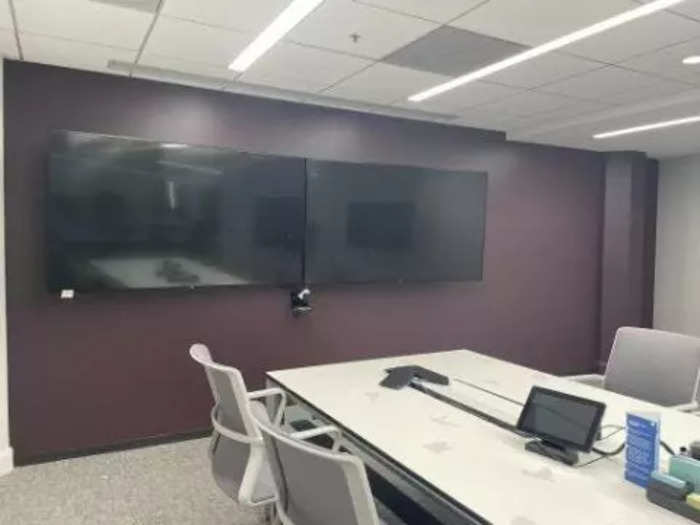 This video conferencing system features two large, flat-screen TVs. It also includes a Logitech camera and a touch screen, great for a hybrid work situation.