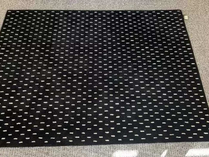 This black Sylvain Willenz rug with white dots is 100% wool.