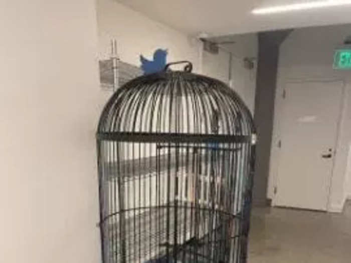 This sculpture looks like an ordinary birdcage at first, but it has a blue Twitter bird welded onto the top.