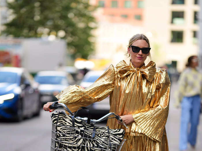 Bicycles are a favorite mode of transport during Copenhagen Fashion Week. This guest pulled up outside Lovechild 1979 in a gold gown and sneakers, because why not?