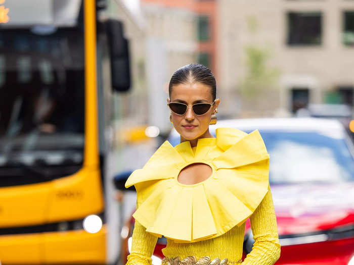 Influencer Nina Sandbech was reminiscent of a pineapple ring outside the Lovechild 1979 show in a yellow applique dress.