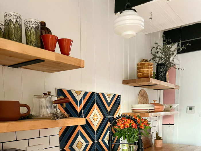 They took out some of the upper cabinets and replaced them with open shelving. Ginther also added a patterned backsplash.