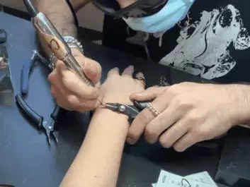 A gif shows the author being "zapped," or having a bracelet welded onto her wrist.