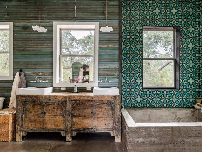 The primary bathroom has a spacious board-formed concrete tub and custom Mexican cement tile.