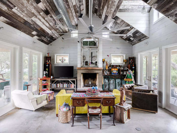 The living room showcases vaulted ceilings adorned with rustic, reclaimed barn wood.