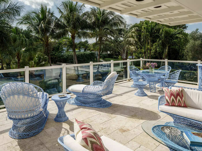 The patio features blue mesh couches, chairs, and tables.