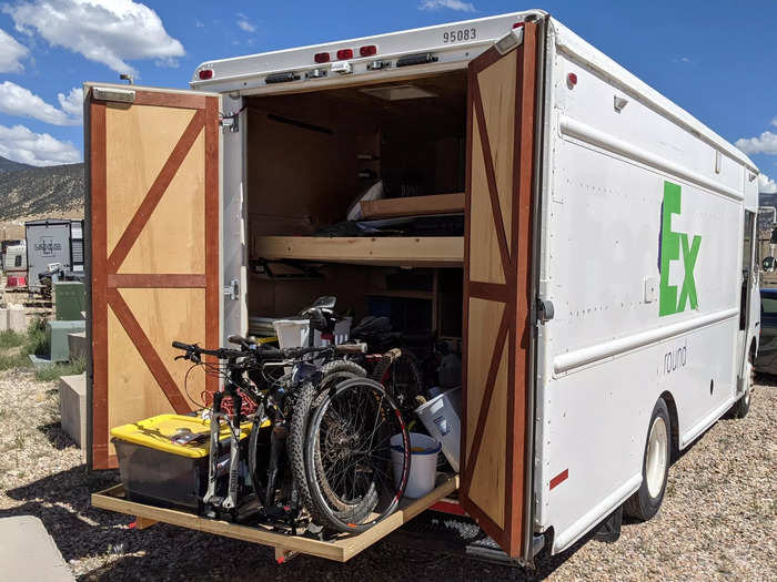 He stores his bicycles in the back of the truck.