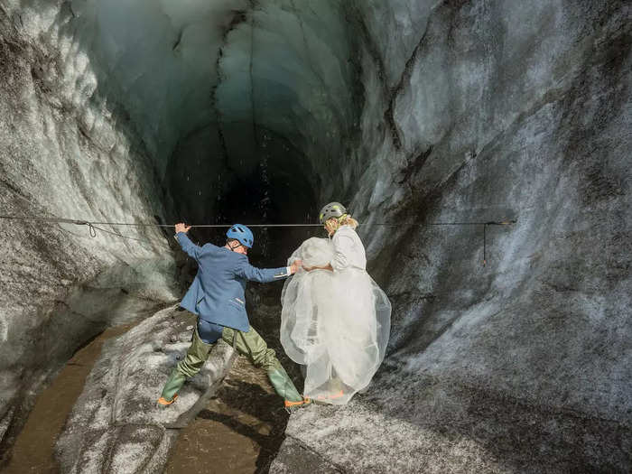 Schofield and Watson climbed into the ice cave in their wedding finery.