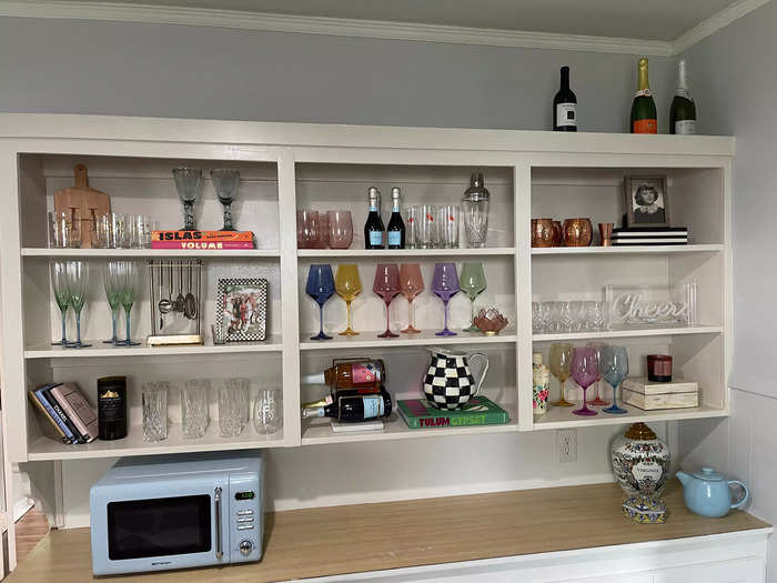 Harris wanted the kitchen to feel "colorful and happy." Many of these glasses were inherited from her great aunt and grandmother.