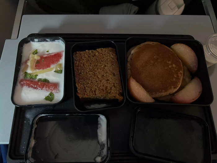 Though not as gourmet as first class, economy still had delicious food. For breakfast, I got pancakes with peaches, coconut yogurt with grapefruit, and a slice of carrot cake.