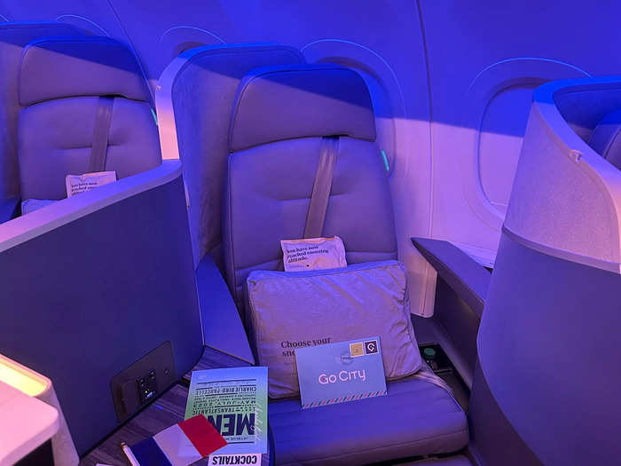 The seats are markedly different — business class offers a private "suite" and a lie-flat chair.