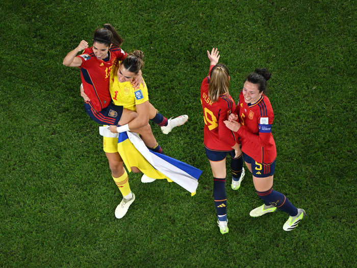 Misa Rodríguez hoisted Alba Redondo up in victory as Olga Carmona and Ivana Andrés joined them in celebrating beating England.