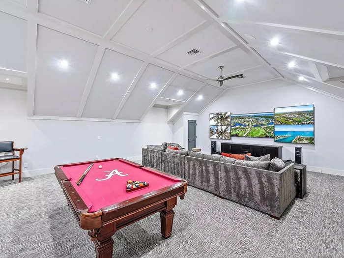 The area includes five TVs and a University of Alabama-themed pool table.