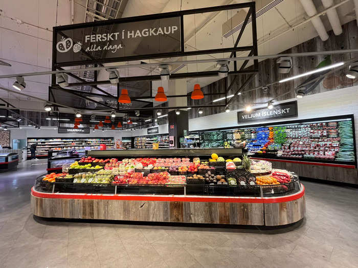 Further inside the store, a full produce section displayed fresh fruits and vegetables.