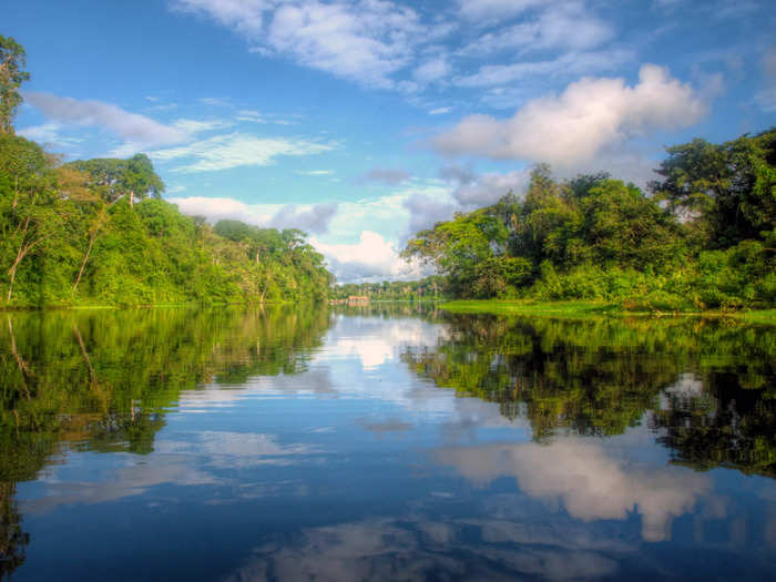 The Amazon River journeys through the Andes Mountains of Peru and flows through Colombia, Ecuador, Bolivia, Venezuela, and Brazil before reaching the Atlantic Ocean.