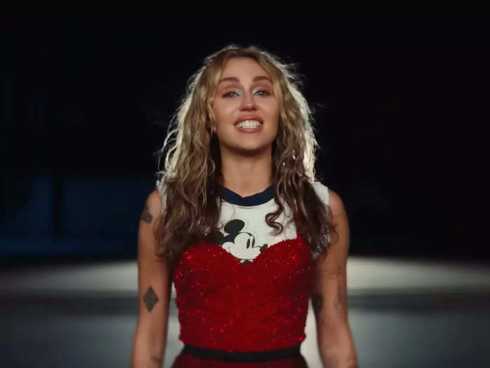 In the video, Cyrus wears a t-shirt featuring the Disney character Mickey Mouse.