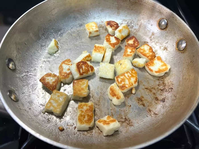 Once the oil is hot, add your halloumi to the pan and turn it with a spoon occasionally, cooking until it