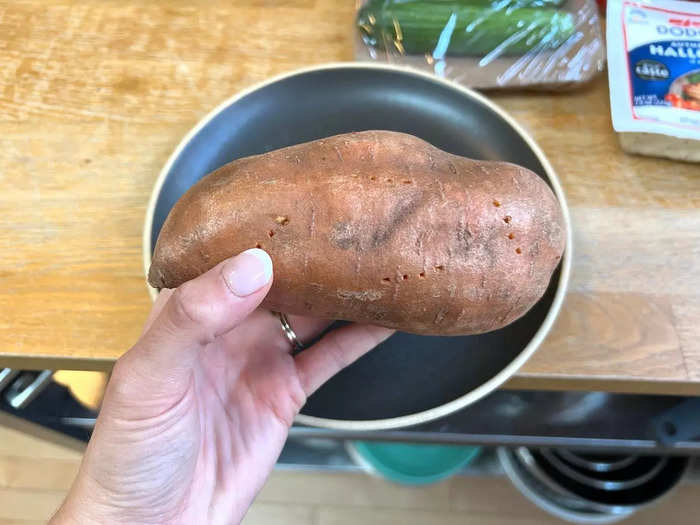 To get started, preheat your oven to 400 degrees. Prick the potato with a fork all over then stick it in the microwave for five minutes.