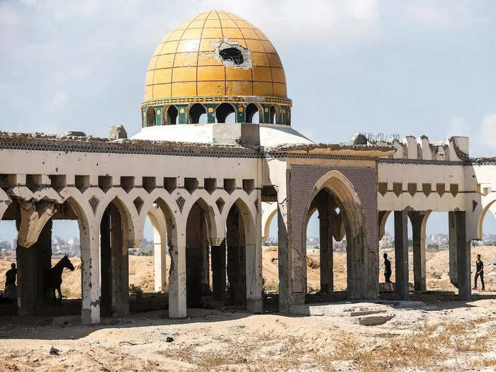 A large missile hole can be spotted in a golden dome, which was once home to the former VIP terminal.