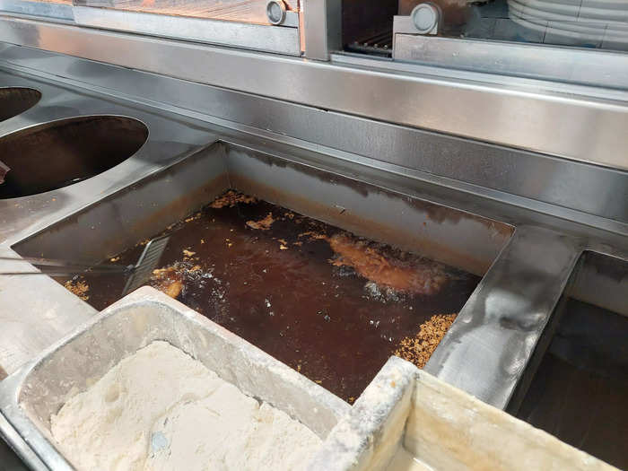 Behind the counter, workers fry the food. Unlike many other shops in the area that use beef dripping, Whitehead