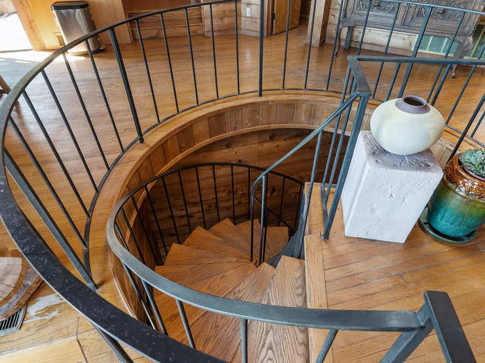 With two additional bedrooms, a bathroom, and a sauna down a spiral staircase.