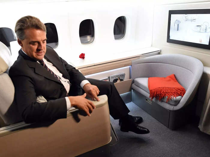 The cabin comes with the expected luxuries like a lie-flat bed, table, ottoman, and television, while its grey and red color scheme gives it a uniquely luxe look.