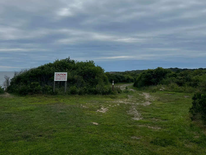 And just to the right of the water is one of the many trails throughout the park — along with a caution sign warning people to stay away from the cliffs.