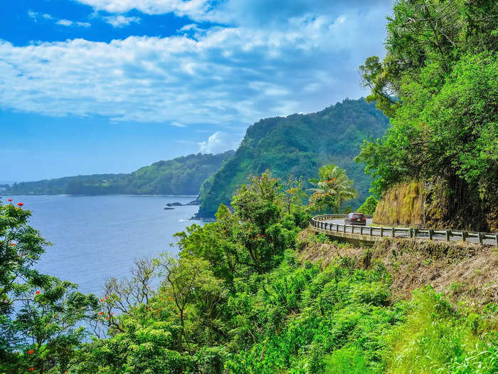 The 52-mile road to Hana in East Maui is a tourist attraction in itself with numerous waterfalls and scenic views along its hairpin turns.