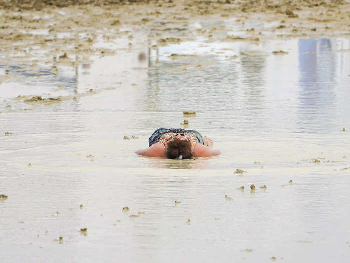 One woman chose to lie in a mud puddle amid the commotion.