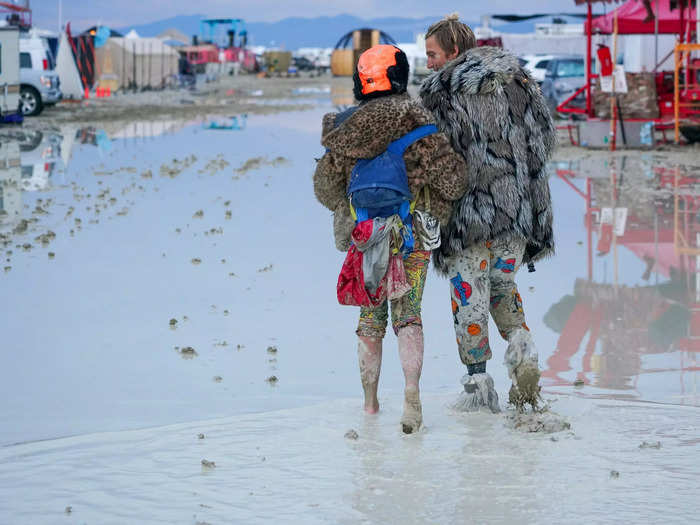 These Burning Man attendees waded through the water to navigate the festival site over the weekend.